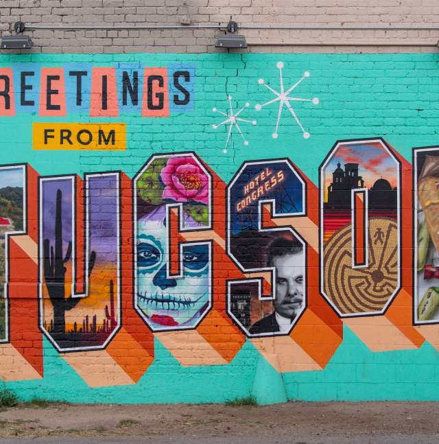 Colorful Mural on brick wall that reads "Greetings from Tucson"