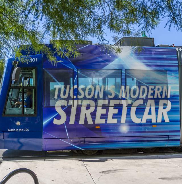 Side of a blue streetcar that reads "Tucson's Modern Streetcar"