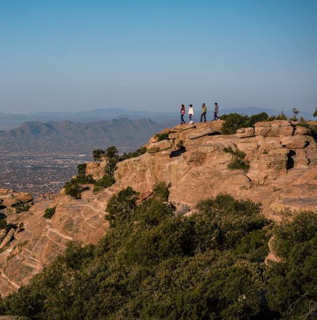 four people hiking on the hoodoos of Mount Lemmon at Windy Vista on the Catalina Mountains