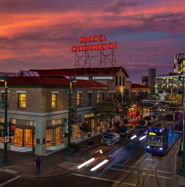 Cityscape of Downtown Tucson with Hotel Congress sign, Sun Link streetcar, and Vibrant Nightlife