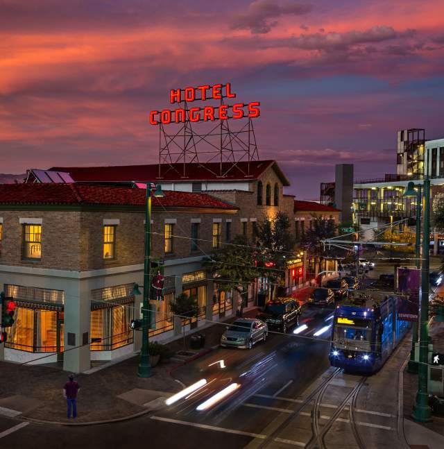 Cityscape of Downtown Tucson with Hotel Congress sign, Sun Link streetcar, and Vibrant Nightlife