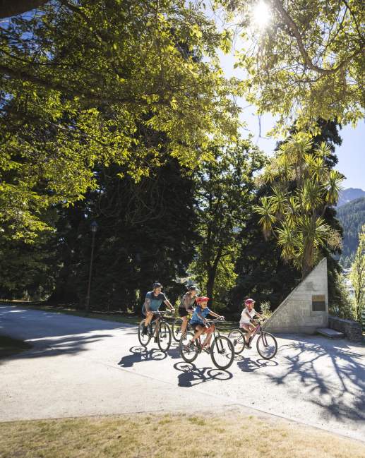 A family biking in the Queenstown Gardens
