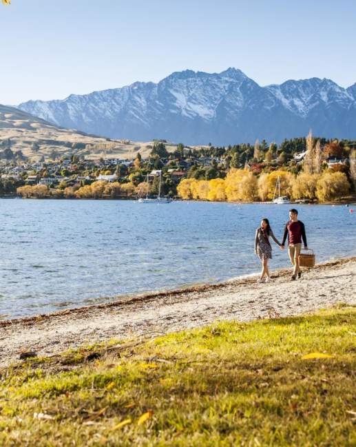 Couple walking around Lake Hayes in Autumn