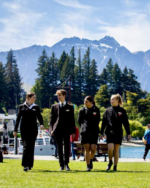 Group of students walking with mountains and lake view in background