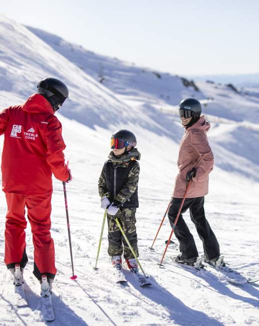 Mother and son having a ski lesson on a snowy mountain