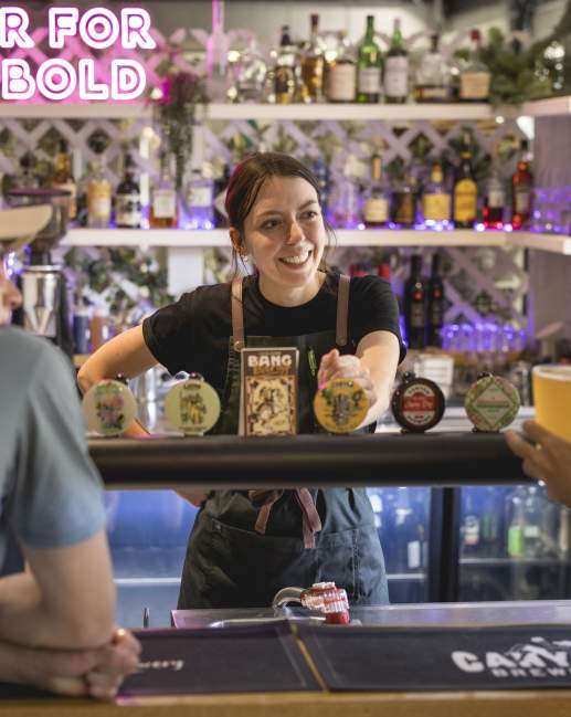 People ordering beer at a bar