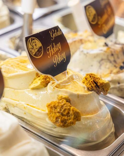 Close up of gelato in a shop with a sign reading Hokey Pokey