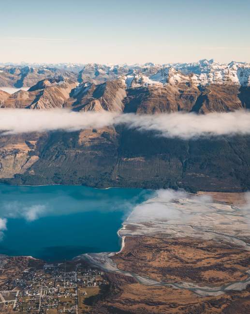 Aerial photo of Glenorchy township with huge mountains in the background