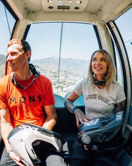 Friends inside a gondola transporting mountain bikes