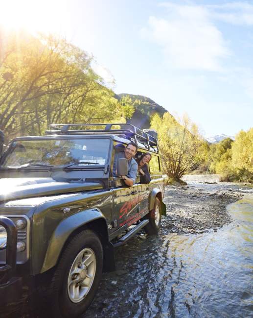 Nomad Safaris truck crossing river in Autumn