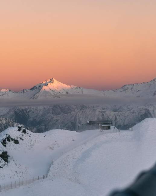 Colourful pink and orange sunrise over snow capped peaks