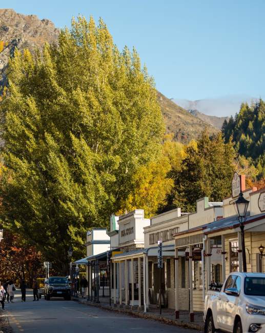 Street lined with old buildings and boutique shops in Arrowtown