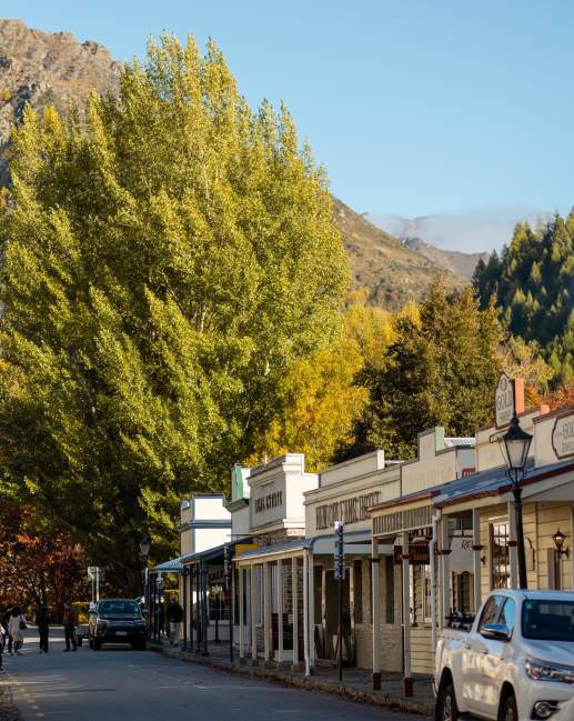 Street lined with old buildings and boutique shops in Arrowtown