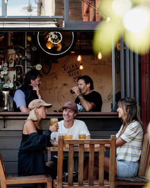 Friends enjoying a pint of beer at Atlas Beer Cafe in Queenstown