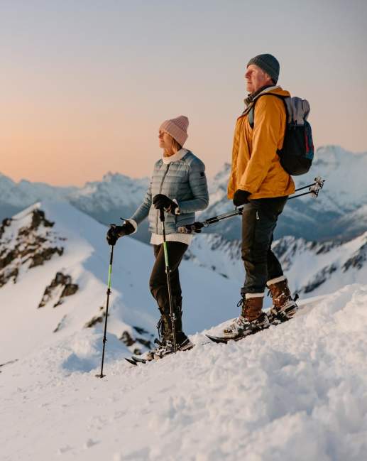 Couple snow shoeing at sunset on Mt Larkins near Glenorchy