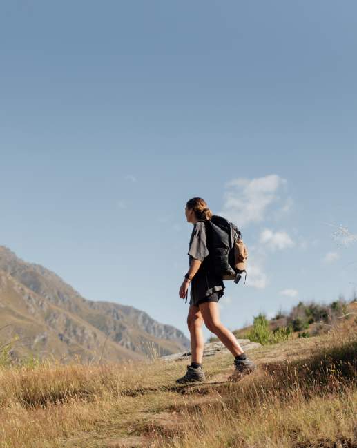 Hiker standing at the top of a hill
