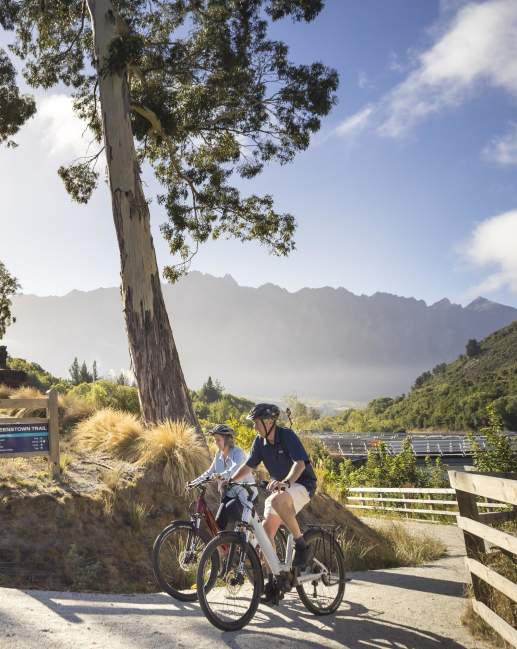 People biking with mountain in the background