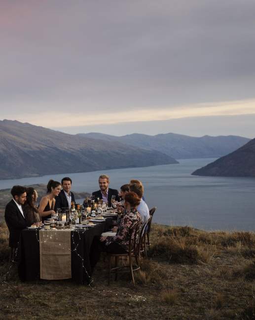 group dining on top of mountain with the Remarkables in the background