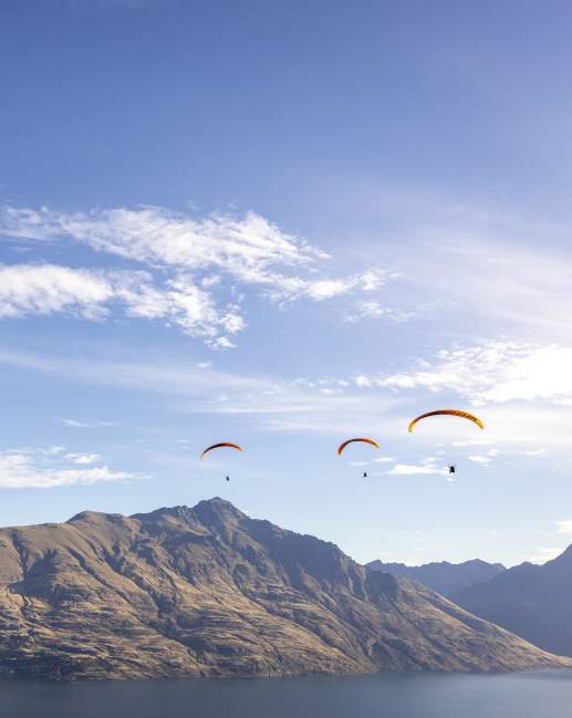 Three paragliders over Cecil Peak