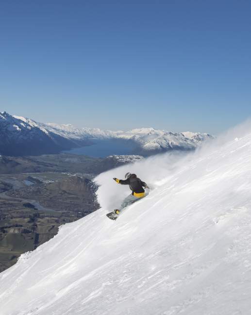 Man snowboarding at Coronet Peak Ski Area