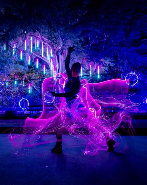 Person in a light up costume at night