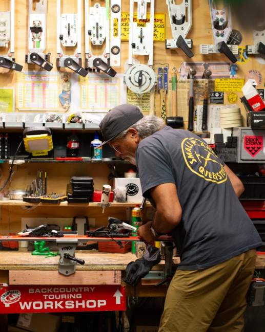 Darryl Tatom, Owner of Small Planet in workshop surrounded by sporting gear