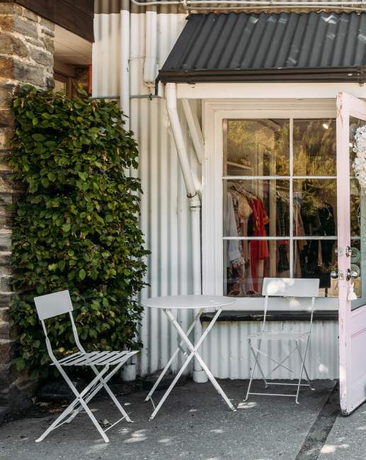 Outside view of a a white, cottage-style looking boutique shop