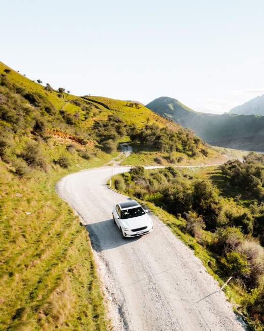 EV driving to Moke Lake with mountains in the background