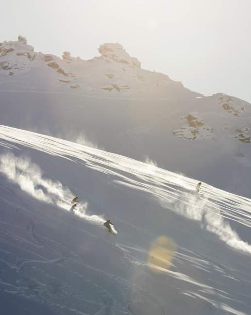 Two skiers shredding the slopes at sunrise
