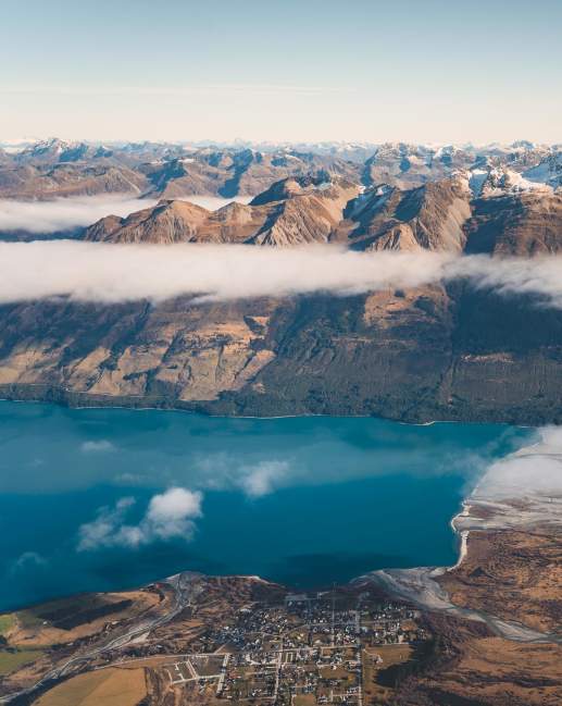 Aerial photo of Glenorchy township with huge mountains in the background