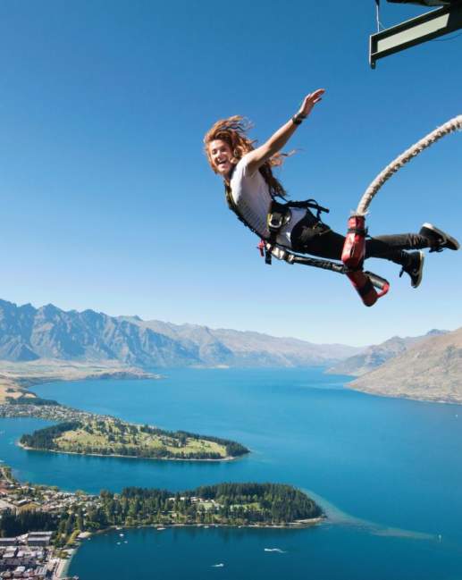 Woman bungy jumping in Queenstown at the AJ Hackett Ledge Bungy