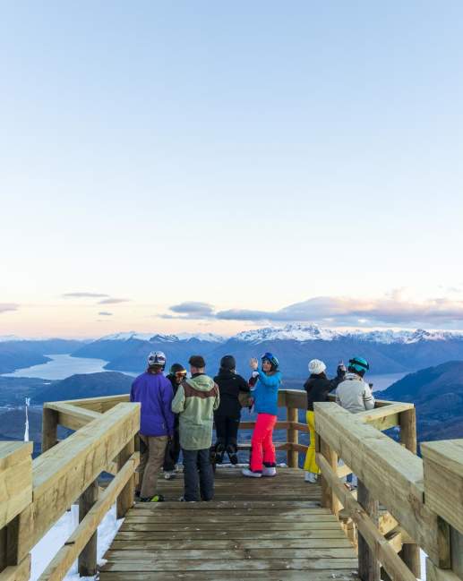 Group of people sightseeing at viewpoint atop of a mountain