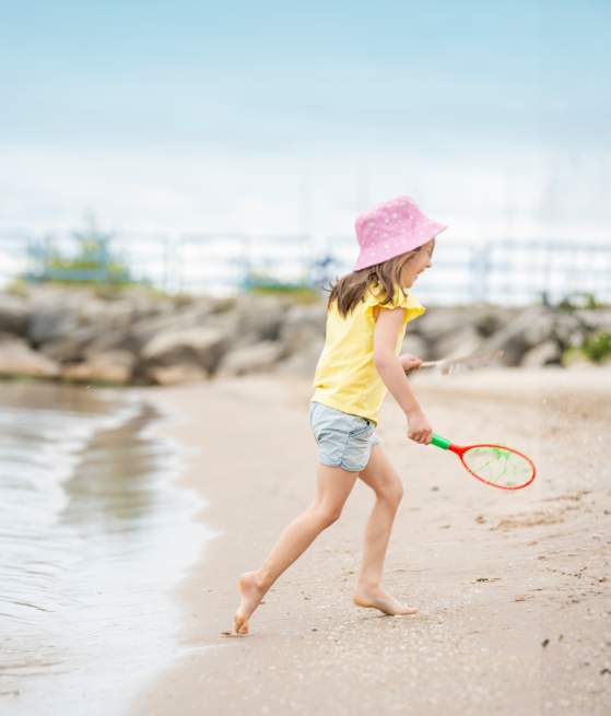 Girl Playing at Lighthouse Park Beach in Manitowoc