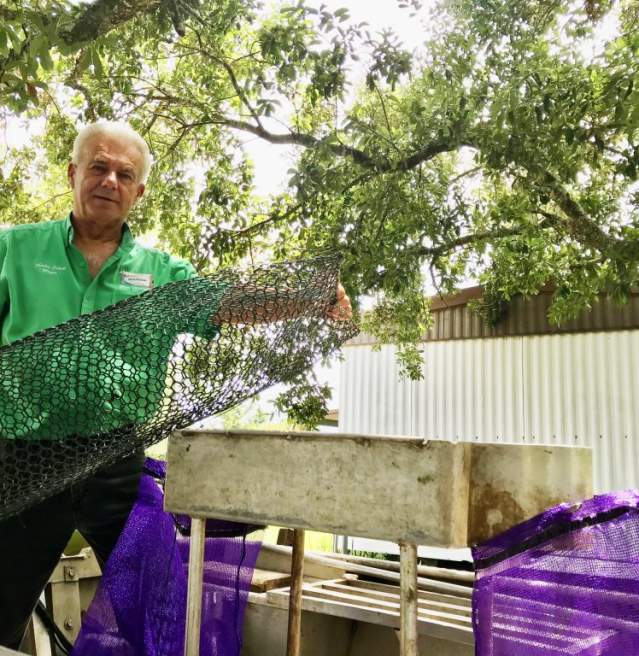 Mayor Sherbin Collette demonstrates his crawfishing equipment outside of his Henderson home.