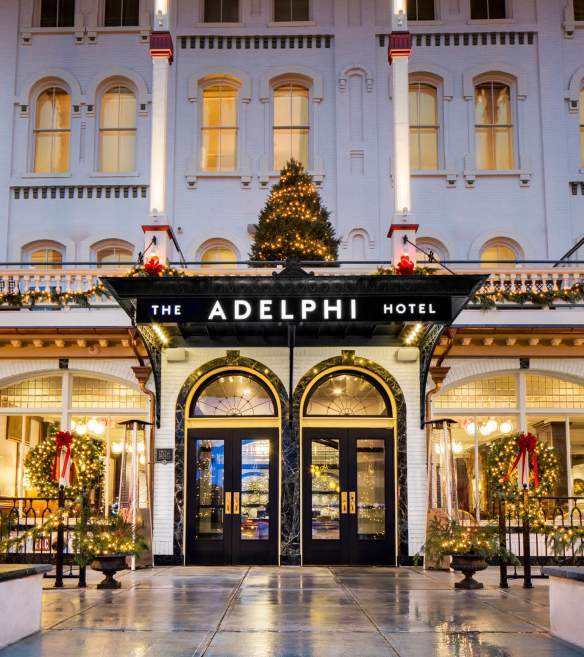 Front of the Adelphi with tiny white lights, decorated lamp posts, wreaths and tree