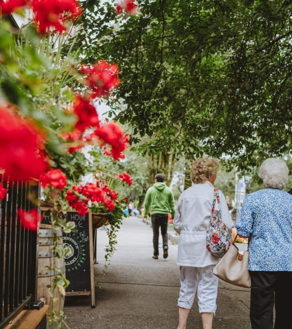 red flowers and women walking
