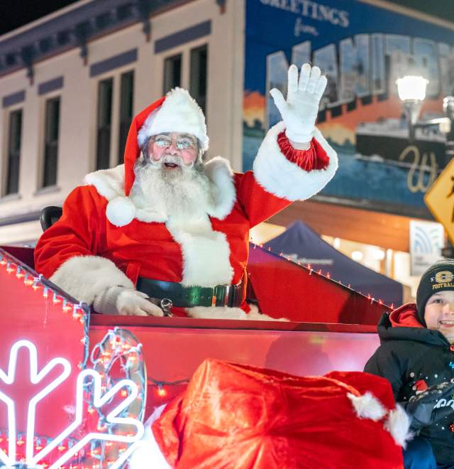 Santa waving with kid in Lakeshore Holiday Parade