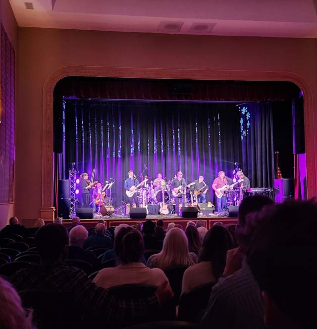 The audience enjoys a live performance at the Martinsville Entertainment Theatre by the Woomblies Rock Orchestra.
