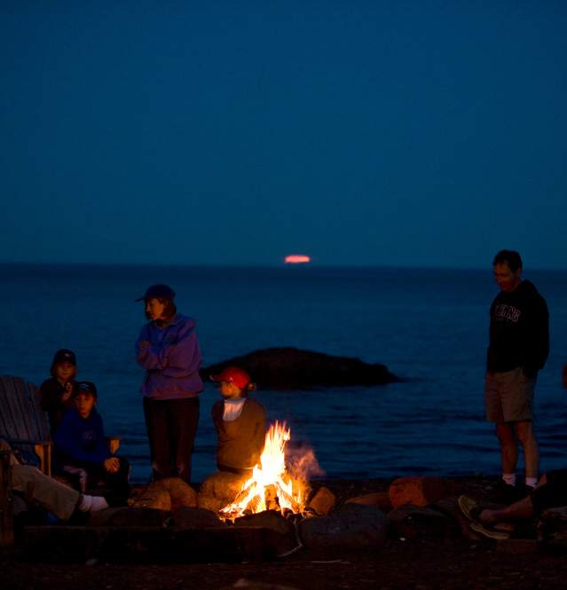 Group having a fire on the beach