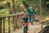 A family mountain biking through a trail in the fall at Clarksville's Rotary Park.