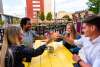 Young adults enjoying drinks at the Sidecar outdoor bar in downtown Fort Wayne.
