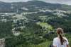 View of town of Haines from mountain top, girl over looking