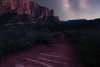 Starry Skies over a dirt hiking trail with logs laid out for steps and towering crimson cliffs in the background in Kolob Canyons, Ut.