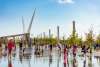 Families enjoying water fountain feature at Oklahoma City's Scissortail Park