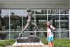 mom and daughter at a bronze statue of Wilma Rudolph