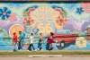 People walking in front of Summer of 66 Mural