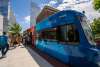 Groups entering and exiting Thunder-themed OKC Streetcar at route stop in downtown Oklahoma City