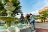 family by a fountain in a historic downtown