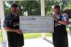 Two men holding a check for second place in Ribfest 2024.