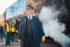 A train conductor stands in front of the Big Boy locomotive